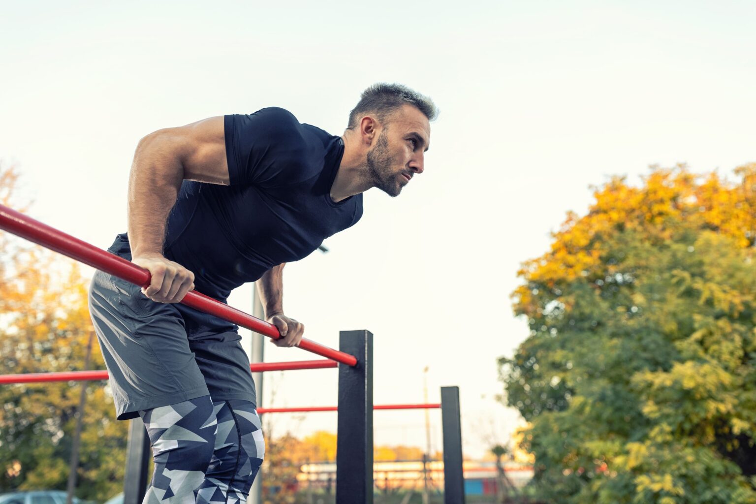 muscular man working out using a bar