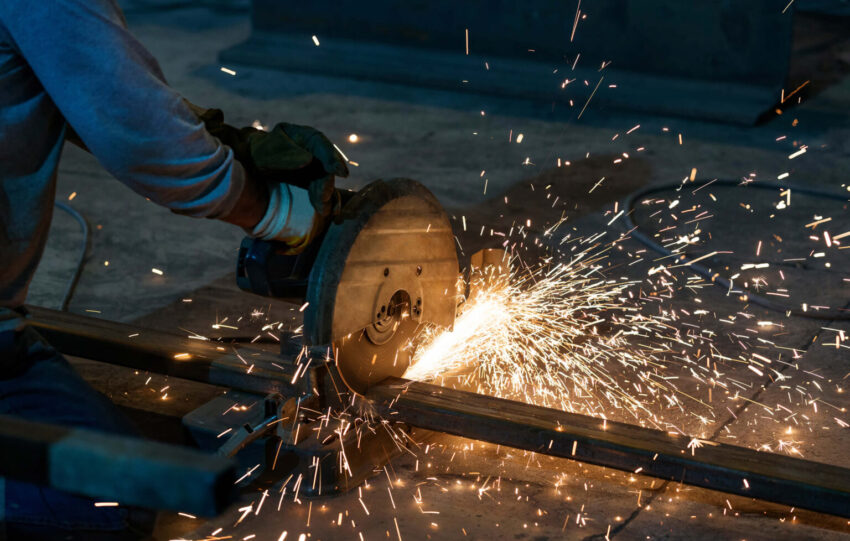 worker is cutting a steel